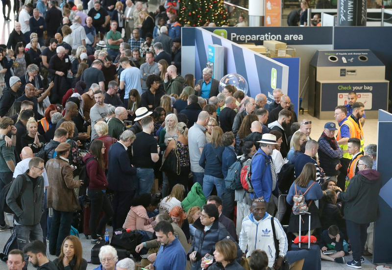 People line up after cancelled flights at Gatwick Airport cause confusion on December 20, 2018